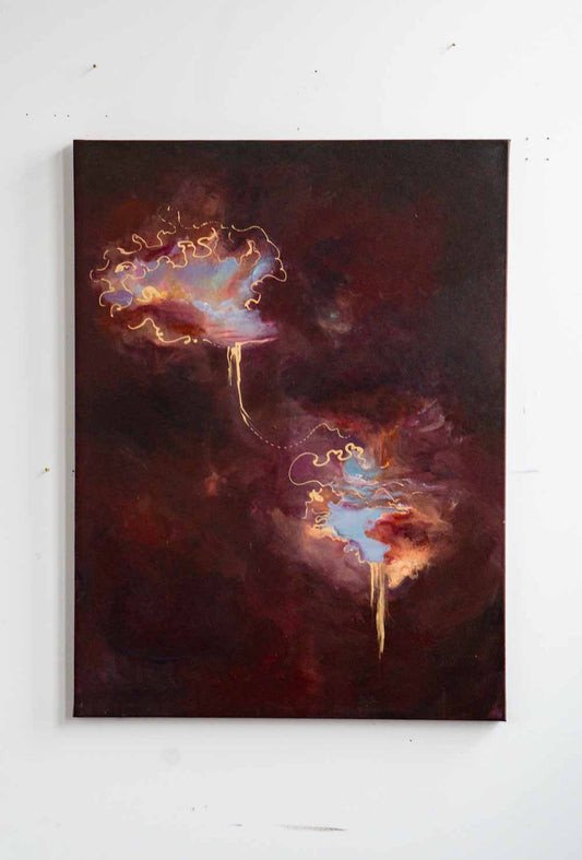Abstract painting of two celestial bodies on a white wall